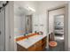 Bathroom features a sliding door, a quartz countertop, and under sink storage at 424 Grape St, Denver, CO 80220