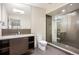 Modern bathroom featuring walk-in glass shower, sleek fixtures, and stone countertop at 424 Grape St, Denver, CO 80220