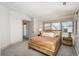 Inviting bedroom with a rustic wooden bed frame, soft neutral tones, and bright natural light at 424 Grape St, Denver, CO 80220