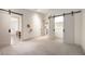 A spacious bedroom offers versatility and sliding barn doors for the closet and bathroom at 424 Grape St, Denver, CO 80220