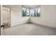 This bedroom shows a large window, neutral colors and carpet, and an adjoining bathroom at 424 Grape St, Denver, CO 80220