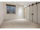 This bedroom features modern sliding doors, a window, and neutral colors at 424 Grape St, Denver, CO 80220