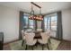 Elegant dining room featuring a modern chandelier, large windows, and a round table with seating for six at 424 Grape St, Denver, CO 80220