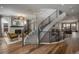 Grand foyer showcasing a curved staircase with modern railing and hardwood floors, inviting and spacious at 424 Grape St, Denver, CO 80220