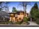 Contemporary home with a stone and wood exterior, featuring a well-maintained lawn and an attached garage at 424 Grape St, Denver, CO 80220