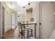 The upper hallway with modern light fixtures and metal railings leads to the home's bedrooms at 424 Grape St, Denver, CO 80220