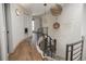 Hallway featuring a curved staircase, wooden flooring, and hanging pendant lights at 424 Grape St, Denver, CO 80220