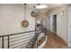 Stylish hallway with unique lighting fixtures, staircase, and wood flooring at 424 Grape St, Denver, CO 80220