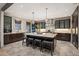 Elegant kitchen featuring dark wood cabinets, a large island with seating, and stone tile flooring at 424 Grape St, Denver, CO 80220