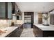 Modern kitchen featuring stainless steel appliances, a large island, and marble countertops at 424 Grape St, Denver, CO 80220