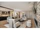 Spacious living room with fireplace, hardwood floors, neutral tones, and open access to the kitchen and staircase at 424 Grape St, Denver, CO 80220