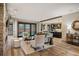 Bright open living room featuring a stone fireplace, modern furniture, and hardwood floors overlooking the kitchen at 424 Grape St, Denver, CO 80220