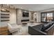 Inviting living room featuring a stone fireplace, open shelving, and comfortable seating, perfect for relaxation at 424 Grape St, Denver, CO 80220