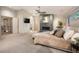 This main bedroom features a stone fireplace, vaulted ceilings, and cozy neutral colors and finishes at 424 Grape St, Denver, CO 80220