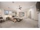 Main bedroom with plush carpet, a ceiling fan, and bright windows at 424 Grape St, Denver, CO 80220