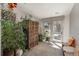 Bright sun room with lots of plants, seating, and exterior access at 424 Grape St, Denver, CO 80220