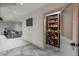 Elegant wine cellar with custom wooden shelving, adjacent to a cozy living area for entertaining at 424 Grape St, Denver, CO 80220