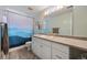 Well-lit bathroom with a mountain themed shower curtain, an expansive vanity, and white cabinets at 12354 W Nevada Pl # 102, Lakewood, CO 80228