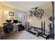 Multi-use exercise room featuring an office area, weights, and bicycles mounted on the wall at 12354 W Nevada Pl # 102, Lakewood, CO 80228