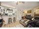 Cozy living area featuring adjacent kitchen with granite countertops and wooden stools at 12354 W Nevada Pl # 102, Lakewood, CO 80228