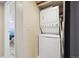 Convenient laundry room with stacked washer and dryer units; next to an adjacent bathroom at 12354 W Nevada Pl # 102, Lakewood, CO 80228