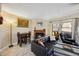 Inviting living room featuring a brick fireplace, comfy seating, and natural light at 12354 W Nevada Pl # 102, Lakewood, CO 80228