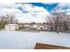 Large backyard with picket fence, storage shed, and plenty of snow on the ground at 6526 S Cherry Way, Centennial, CO 80121