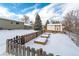 Spacious backyard featuring garden beds, shed, partial fencing, and green home exterior at 6526 S Cherry Way, Centennial, CO 80121