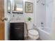 Bathroom with a tiled shower and tub, a stylish vanity, and updated fixtures at 6526 S Cherry Way, Centennial, CO 80121