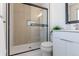 Modern bathroom featuring a glass-enclosed shower with sleek black hardware and a white vanity at 6526 S Cherry Way, Centennial, CO 80121