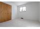 Empty bedroom with plush carpet, a double-door closet, and a window providing natural light at 6526 S Cherry Way, Centennial, CO 80121