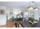 Open-concept kitchen and dining area with stylish light fixtures and views of the island and living space at 6526 S Cherry Way, Centennial, CO 80121