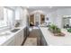 Modern kitchen with sleek stainless steel appliances, an island, and an open floor plan to the living room at 6526 S Cherry Way, Centennial, CO 80121