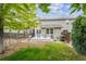 A backyard with a deck, a grassy lawn, and a wooden privacy fence at 9316 Harrison St, Thornton, CO 80229