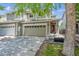 Charming front exterior showcasing a two-story townhome with a two car garage and well-maintained lawn at 9316 Harrison St, Thornton, CO 80229