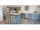 Contemporary kitchen featuring stainless steel appliances, a center island, and sleek gray cabinets at 9316 Harrison St, Thornton, CO 80229