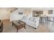 Bright living room featuring a comfortable sofa and seamless transition to the modern kitchen at 9316 Harrison St, Thornton, CO 80229