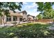 Landscaped backyard featuring lush green lawn and large stone patio at 18647 E Berry Dr, Aurora, CO 80015