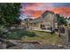 Spacious backyard with a patio, lush lawn, and privacy fence, perfect for outdoor entertaining at 18647 E Berry Dr, Aurora, CO 80015