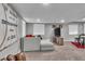 Basement Gathering room with a large sectional sofa, modern decor, and lots of natural light at 18647 E Berry Dr, Aurora, CO 80015