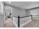 The second-floor hallway features new carpet, modern railings, and easy access to the bedrooms at 18647 E Berry Dr, Aurora, CO 80015