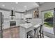 Bright kitchen with stainless appliances, subway tile backsplash, quartz counters and door to patio at 18647 E Berry Dr, Aurora, CO 80015