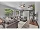 Spacious living room with stone fireplace, large windows, and comfortable seating at 18647 E Berry Dr, Aurora, CO 80015