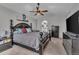 Spacious main bedroom with dark furniture, ceiling fan, and ensuite bathroom at 18647 E Berry Dr, Aurora, CO 80015