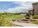 Expansive backyard features manicured landscaping, outdoor entertaining areas, lush lawns and a covered patio at 2466 Spruce Meadows Dr, Broomfield, CO 80023