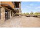 Backyard covered patio with stone facade, wood beam ceiling, and outdoor seating area at 2466 Spruce Meadows Dr, Broomfield, CO 80023