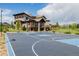 Spacious backyard basketball court with a house in the background, perfect for sports enthusiasts at 2466 Spruce Meadows Dr, Broomfield, CO 80023