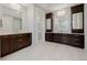 Luxurious bathroom with double vanities, white tile, and modern fixtures at 2466 Spruce Meadows Dr, Broomfield, CO 80023