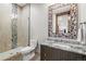 Bathroom with a tiled glass shower, granite countertop vanity, and decorative mosaic mirror at 2466 Spruce Meadows Dr, Broomfield, CO 80023