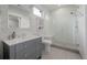 Elegant bathroom features a vanity with a large decorative mirror and walk-in shower with a glass door at 2466 Spruce Meadows Dr, Broomfield, CO 80023